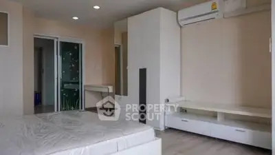 Modern bedroom with built-in storage and air conditioning in a stylish apartment.