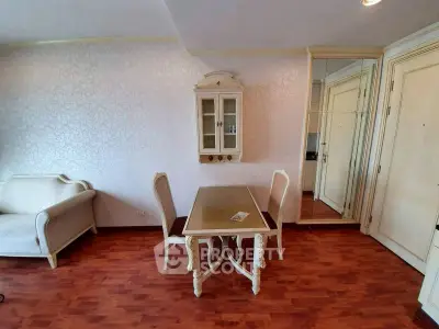 Charming living room with elegant furniture and wooden flooring in a cozy apartment.