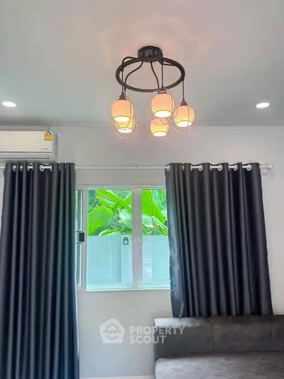Modern living room with stylish lighting and large window with curtains