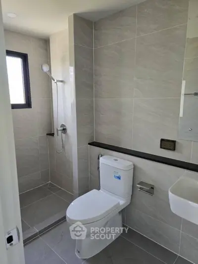 Modern bathroom with sleek tiles and walk-in shower design