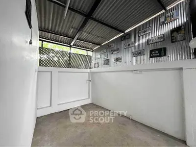 Spacious storage area with corrugated metal walls and natural light.