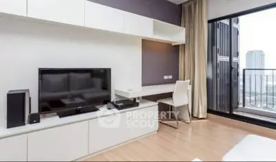 Modern living room with sleek entertainment unit and city view balcony.