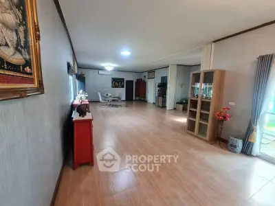 Spacious living room with wooden flooring and elegant decor