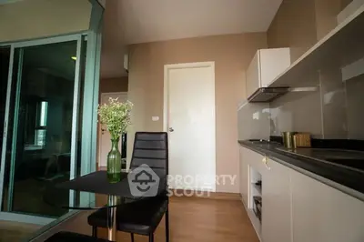 Modern kitchen with sleek design and dining area in stylish apartment