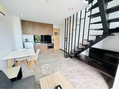Modern duplex apartment with sleek kitchen and stylish staircase