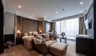 Luxurious living room with elegant decor and large windows offering natural light.