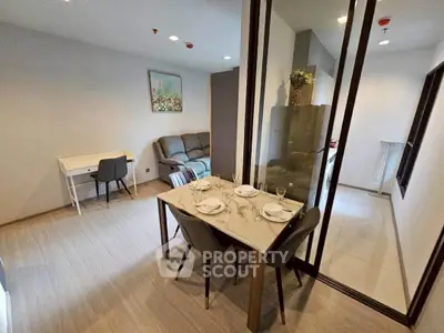 Modern living room with dining area and stylish decor in a contemporary apartment.