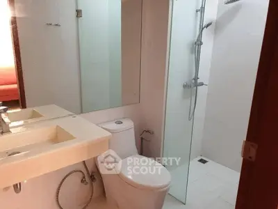 Modern bathroom with glass shower and sleek fixtures