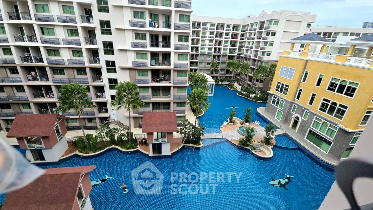 Luxurious condominium complex with stunning pool view and modern architecture.