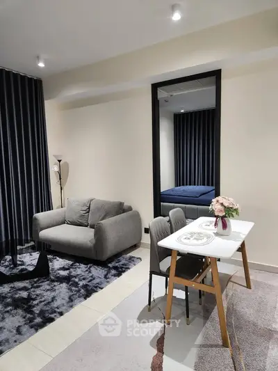 Modern living room with cozy sofa and dining area, featuring elegant decor and stylish furnishings.