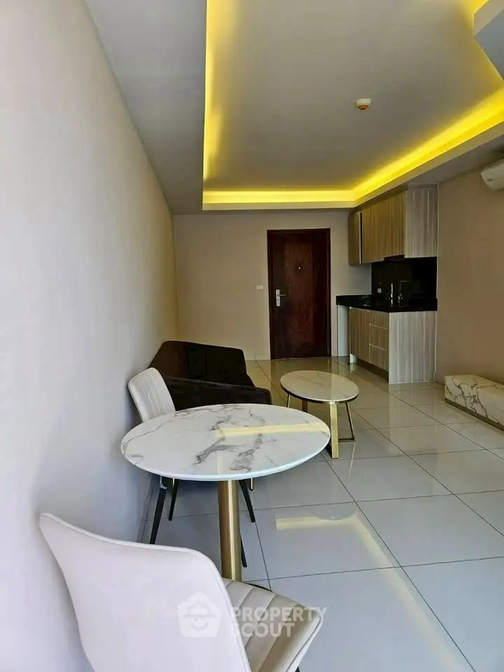 Modern living room with sleek furniture and open kitchen layout