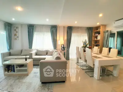 Spacious modern living and dining area with elegant decor and ample natural light.