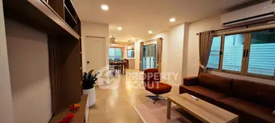 Spacious modern living room with stylish furniture and open layout, perfect for family gatherings.