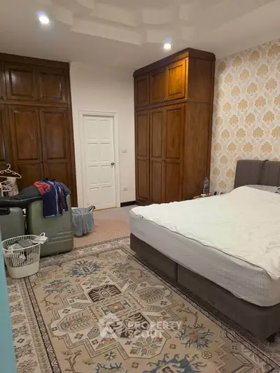 Spacious bedroom with elegant wooden wardrobes and cozy decor