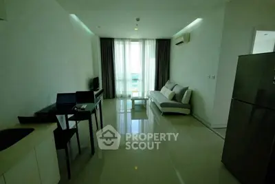 Modern living room with sleek furniture and large windows in a contemporary apartment.