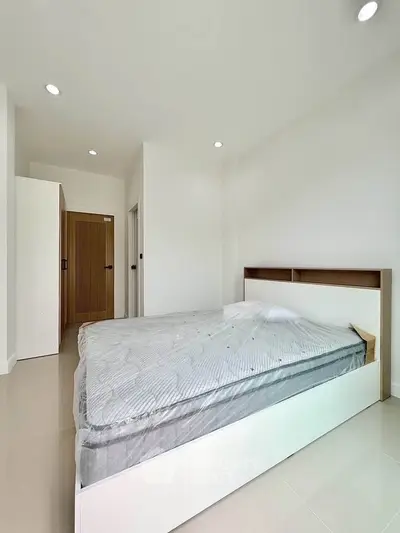 Spacious minimalist bedroom with modern design and ample natural light