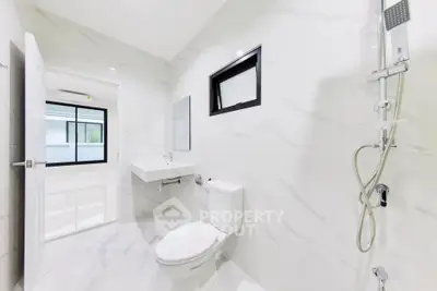 Modern white bathroom with sleek fixtures and natural light