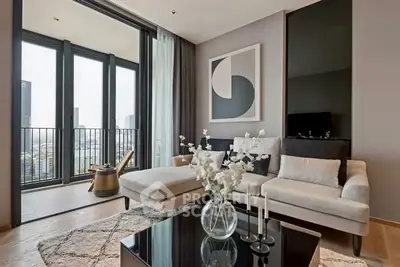 Elegant living room with modern decor and access to a spacious balcony with city views.
