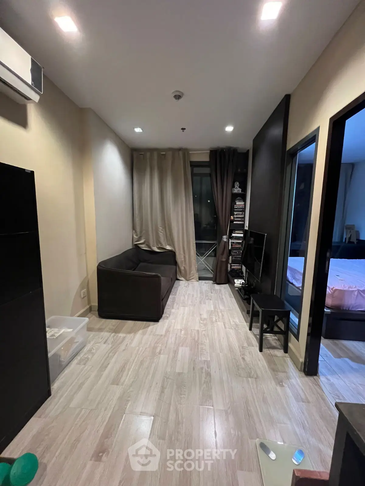 Cozy living room with modern decor and adjacent bedroom view