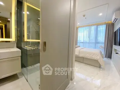 Luxurious modern bedroom with ensuite bathroom and large windows offering natural light.