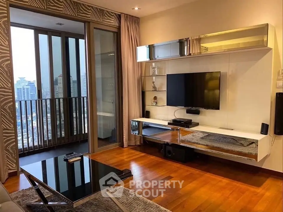 Modern living room with city view, sleek TV setup, and elegant wooden flooring.