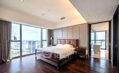 Luxurious bedroom with stunning city view and elegant wooden flooring.