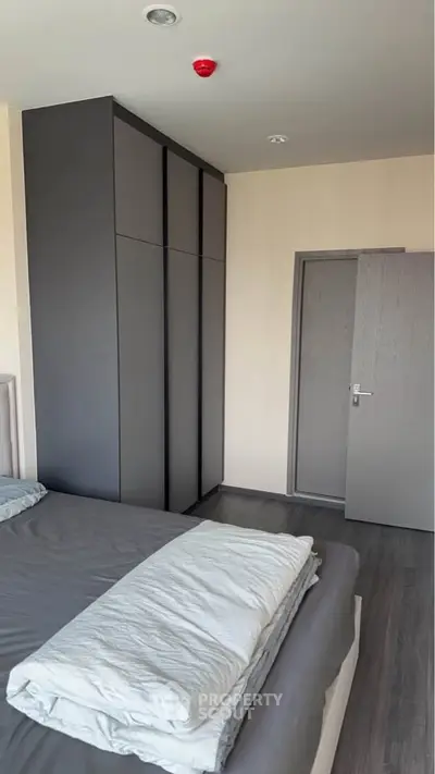 Modern bedroom with sleek wardrobe and cozy bedding