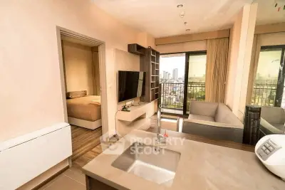 Modern open-plan apartment with city view, featuring sleek kitchen and cozy living area.