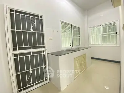 Spacious kitchen with modern fixtures and ample natural light, featuring a sleek closed layout design.
