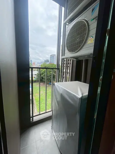 Compact balcony with air conditioning unit and city view