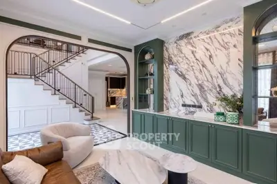 Luxurious living room with elegant marble accents and stylish furniture, perfect for modern living.