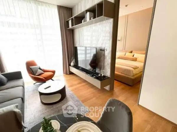 Modern living room with stylish decor and adjacent cozy bedroom