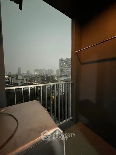 City view from a high-rise balcony at dusk, showcasing urban skyline and modern architecture.