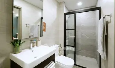 Modern bathroom with sleek design, glass shower, and stylish fixtures.