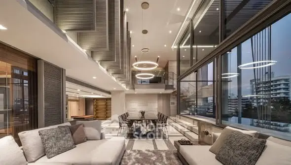 Luxurious modern living room with floor-to-ceiling windows and elegant lighting