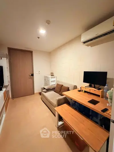 Cozy living room with modern furniture and air conditioning, perfect for relaxation and entertainment.