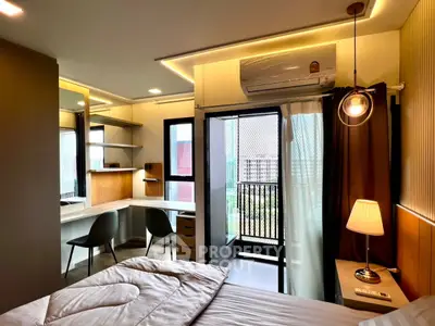 Modern bedroom with balcony access and stylish workspace in a contemporary apartment.