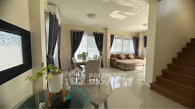 Spacious living room with elegant dining area and natural light