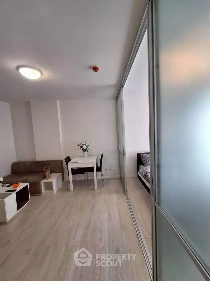 Modern living room with sliding glass partition and minimalist decor