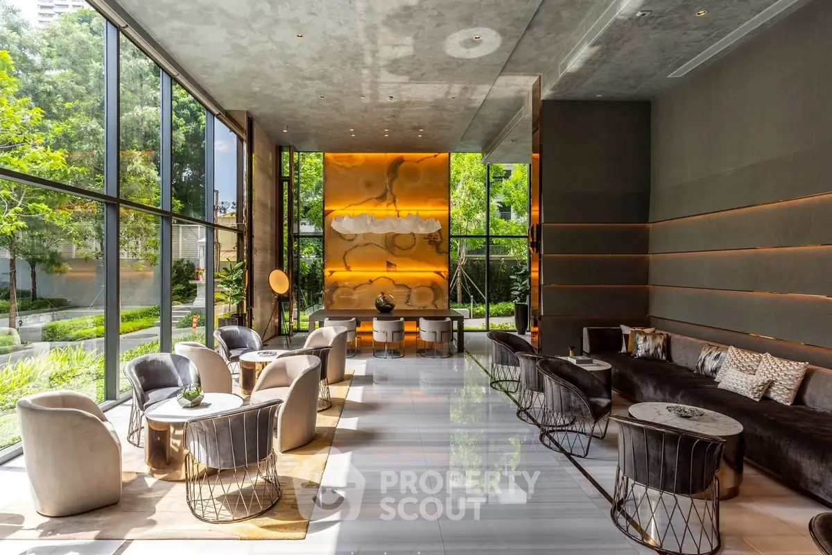 Luxurious modern lobby with floor-to-ceiling windows and elegant seating area.