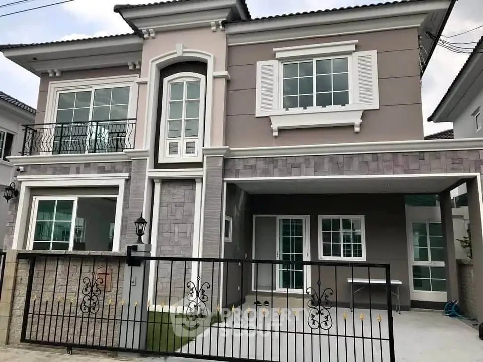 Elegant two-story house with modern facade and spacious driveway in a serene neighborhood.