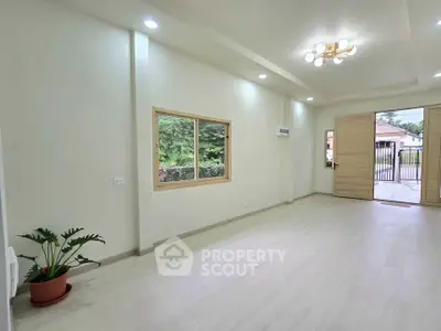 Spacious modern living room with large windows and elegant lighting, perfect for family gatherings.