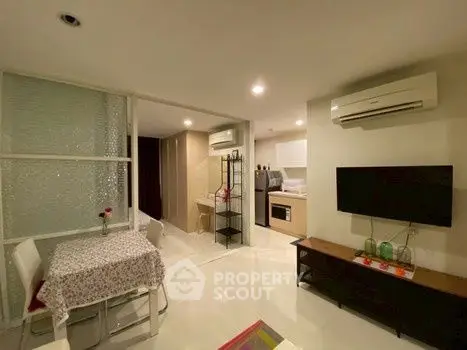 Modern open-plan living room with dining area and air conditioning