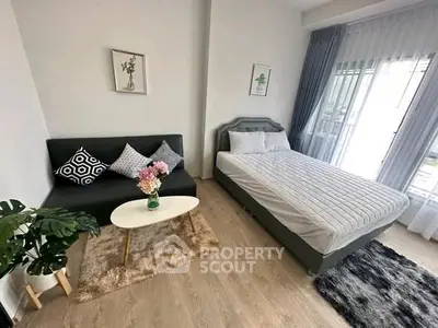 Chic modern bedroom with cozy sofa and stylish decor, perfect for urban living.