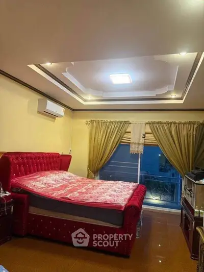 Luxurious bedroom with elegant red bed and stylish ceiling design, perfect for comfort and relaxation.