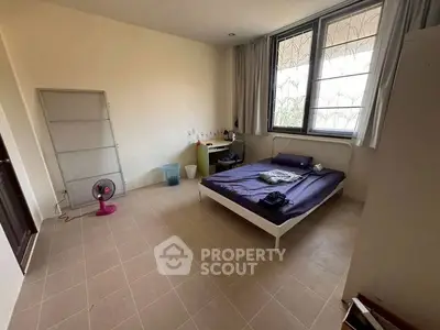 Spacious bedroom with large windows and minimalist decor, perfect for natural light lovers.
