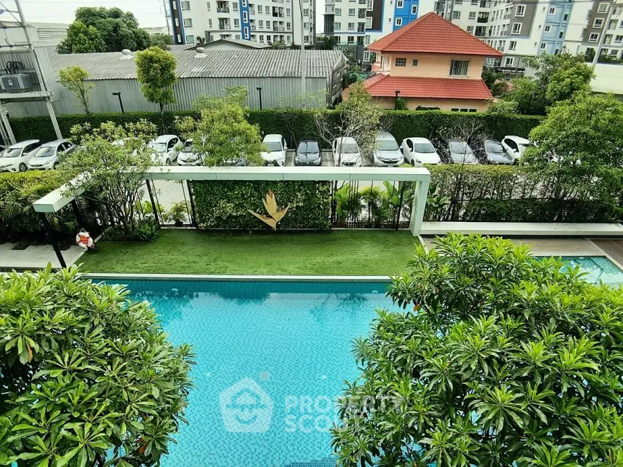 Stunning pool view with lush greenery and modern apartment buildings in the background.