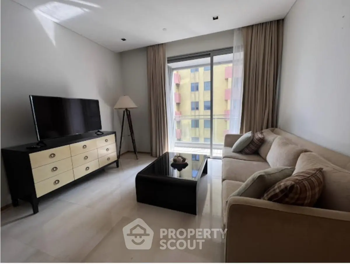 Modern living room with sleek furniture and large window view