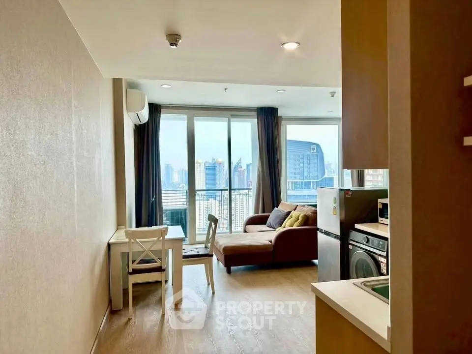 Modern living room with city view, featuring cozy seating and dining area, ideal for urban living.