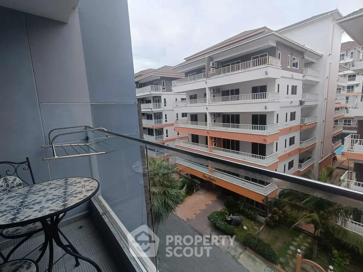 Charming balcony view of modern apartment complex with stylish outdoor furniture.